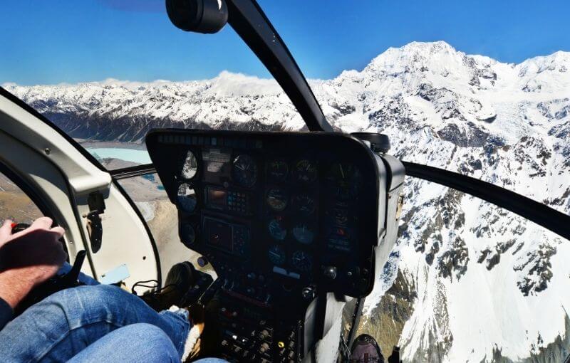 View from Helicopter cockpit of snow on mountains